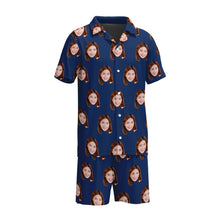 Load image into Gallery viewer, A navy blue short sleeve men's pajama set with a pattern of faces, displayed against a yellow background